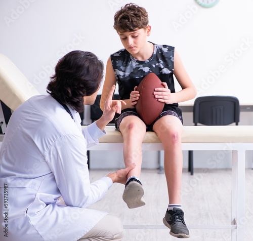 Boy american football player visiting young doctor traumatologis photo