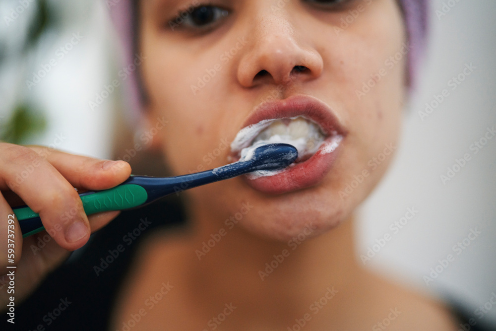 Crop lady brushing teeth with closed eyes Crop lady brushing teeth with closed eyes
