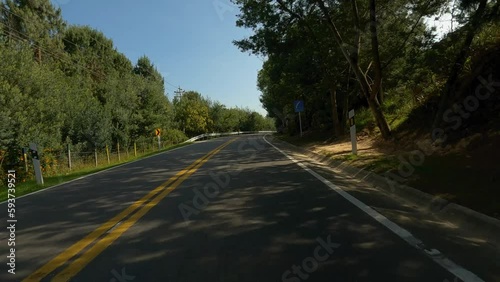 Driving in a highway near to the forest and lake