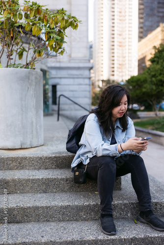 Normal person downtown using cell phone. photo