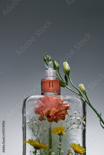 skin rejuvenation with ice massage and cosmetics beige background