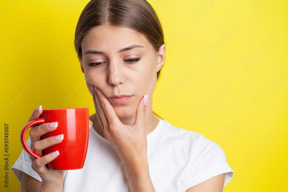 A young woman feels a toothache and holds the place of pain with her hands A young woman feels a toothache and holds the place of pain with her hands