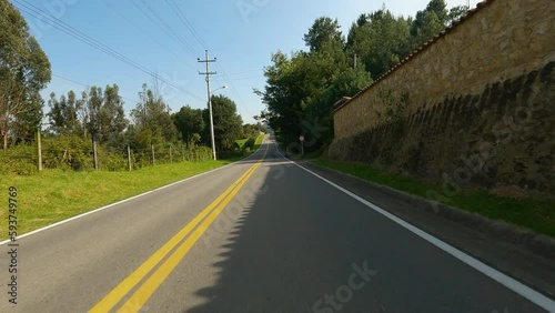 Driving in a highway near to the forest and lake