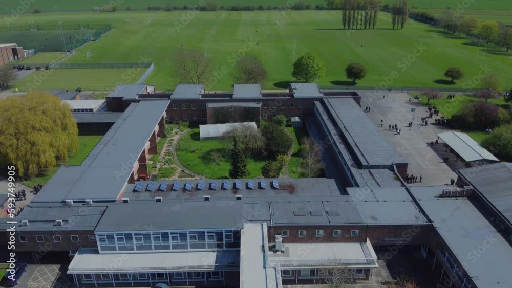 Drone shot 50fps. Birds eye view of secondary school playground. School children playing on the school yard. Filmed East Yorkshire. England. Drone shot 50fps. Birds eye view of secondary school playground. School children playing on the school yard. Filmed East Yorkshire. England.