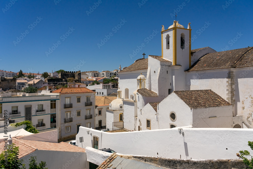 Santiago of Tavira church in the old town of the beautiful city of Tavira in a sunny day. Algarve region, Portugal.
