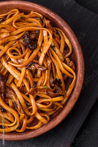 Delicious noodles or udon with mushrooms, salt, spices and herbs