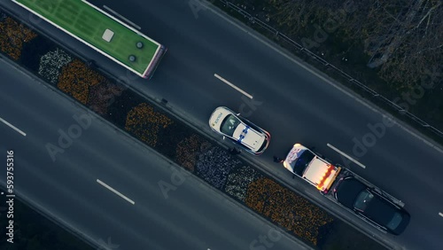 Aerial spinning shot night Car accident in european city. Police flashlights, traffic police draws up a place of an accident, a damaged car is evacuated by a tow truck. Car crashed into a city bus