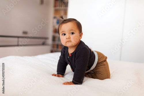 BABY CRAWLING ON BED photo