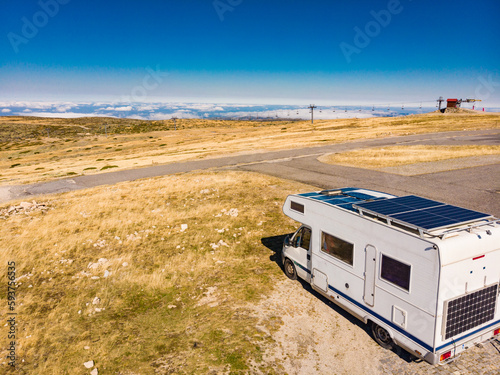 Caravan solar panels on roof camp in mountains. Aerial view