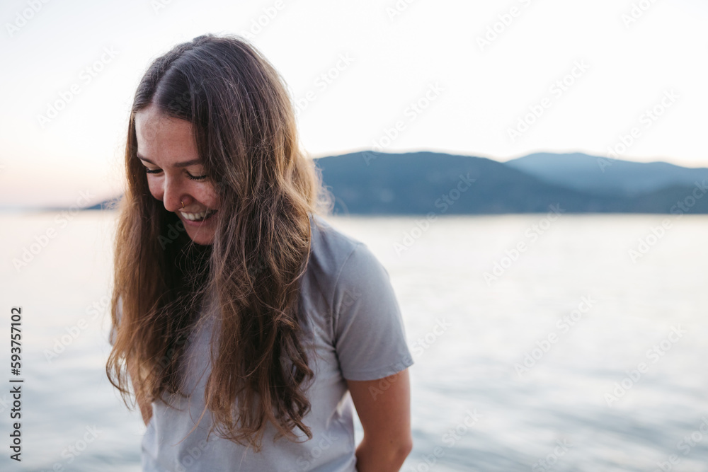 Smiling, happy young woman near the ocean water. Smiling, happy young woman near the ocean water.