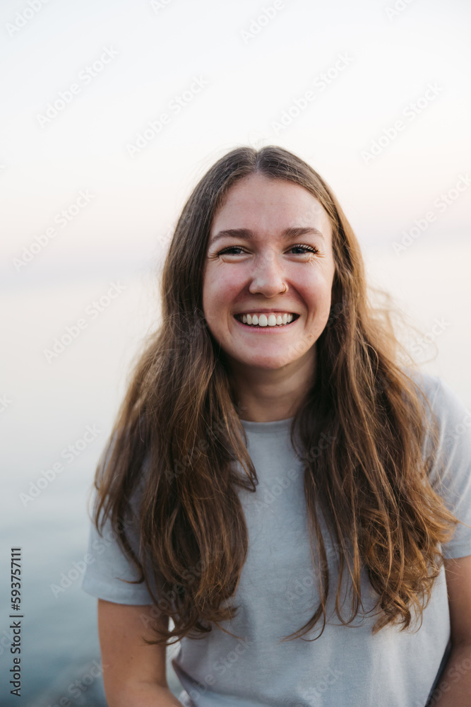 Smiling, happy young woman near the ocean water. Smiling, happy young woman near the ocean water.