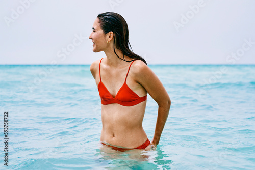 Calm woman swimming in rippling sea
