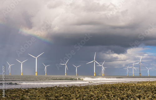 The Windfarm just off Coatham Beach between South Gare and Redcar. The windmills sit under a rainy sky and just a hint of a rainbow. photo