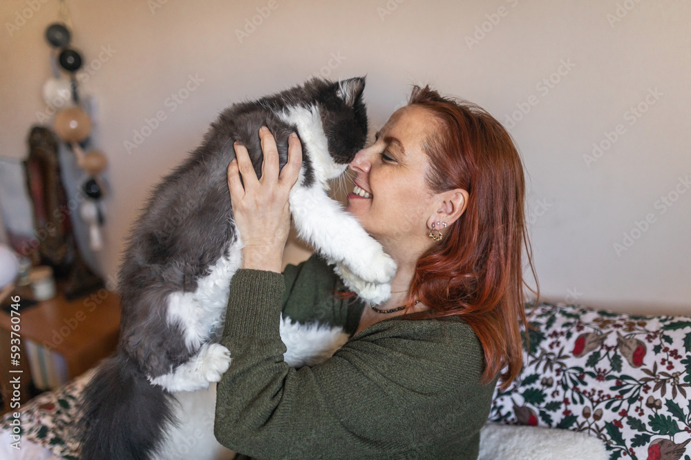 mature woman with her cat at home mature woman with her cat at home