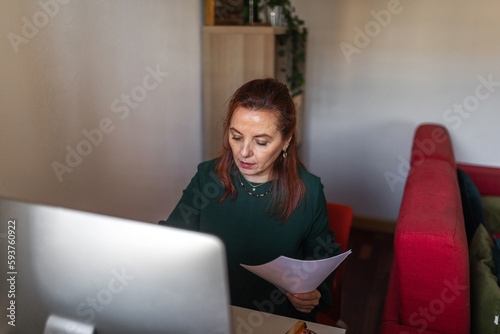 mature woman working from home photo