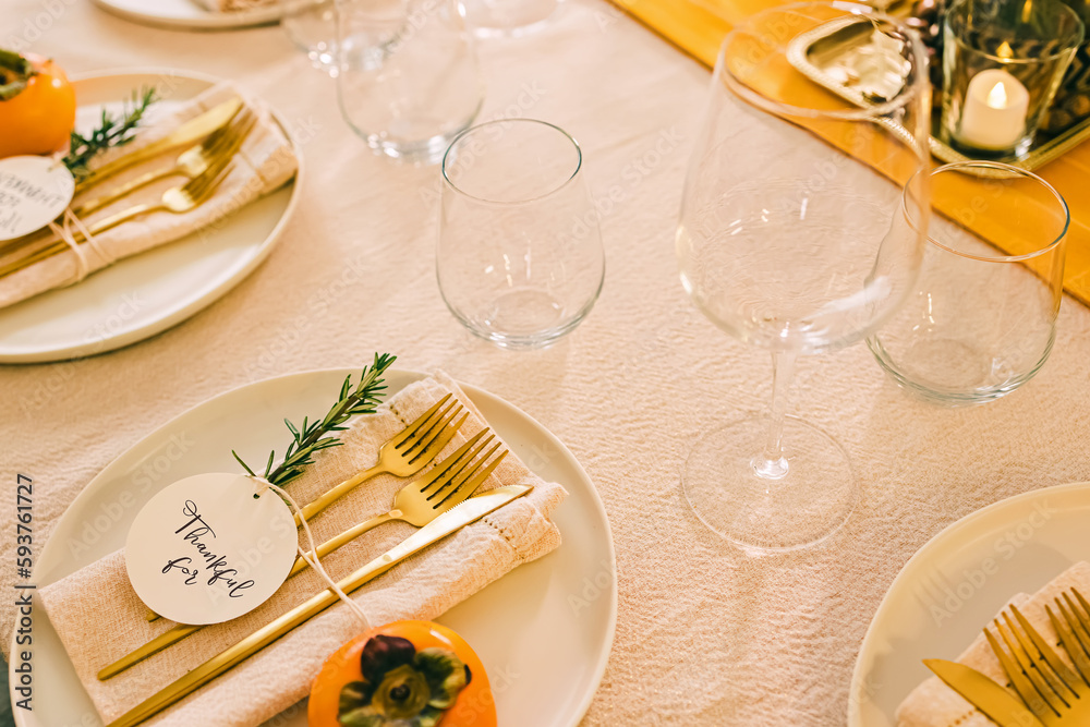 Thanksgiving dinner table setting in golden colors.