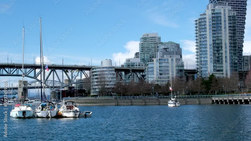 Bridge to greenville and water bus passing under the bridge Nature Canada Vancouver Pacific Ocean Pier and pillars on the pier Granville Island aquabus Skyscrapers in the background 2023 Canada Bridge to greenville and water bus passing under the bridge Nature Canada Vancouver Pacific Ocean Pier and pillars on the pier Granville Island aquabus Skyscrapers in the background 2023 Canada