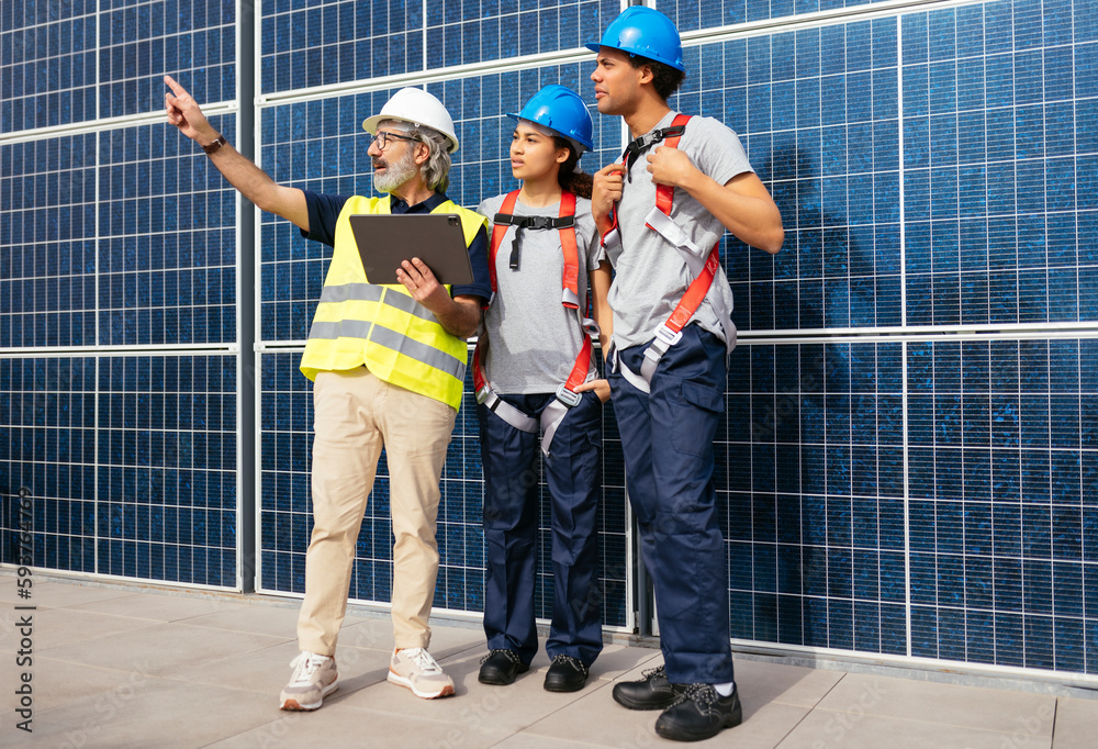 © BONNINSTUDIO/Stocksy - Engineers on solar power station © BONNINSTUDIO/Stocksy - Engineers on solar power station
