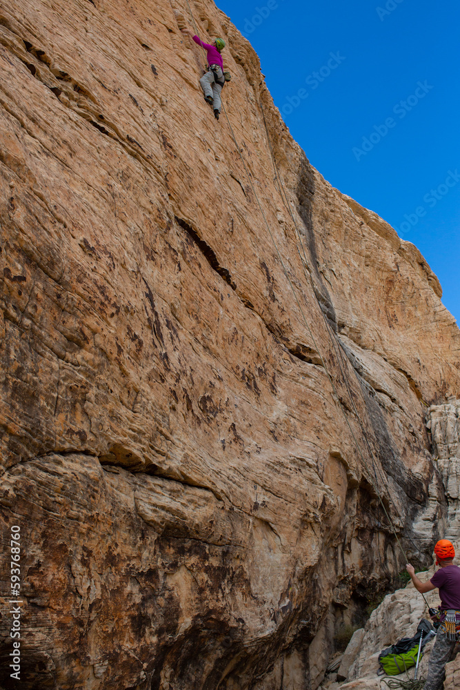 climber on a cliff with belay