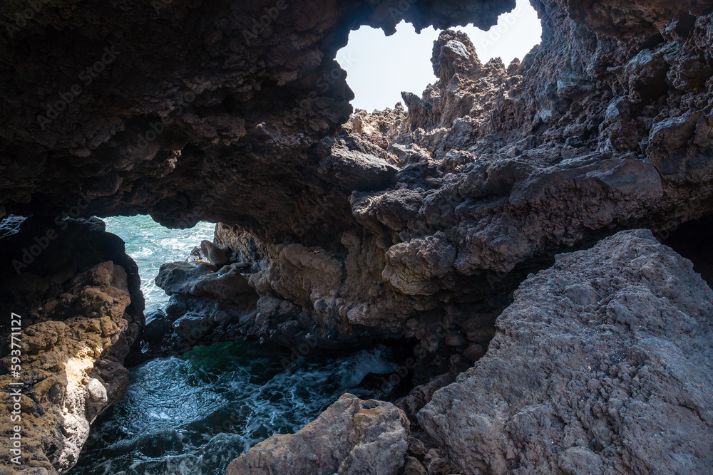 Beautiful coastline with stone caves at Muelle de Orchilla on the southwest coast of El Hierro. Canary Islands