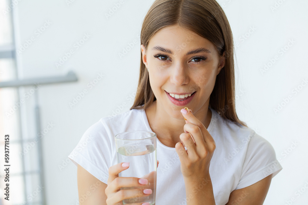 Beautiful Young Woman Taking Yellow Fish Oil Pill Beautiful Young Woman Taking Yellow Fish Oil Pill