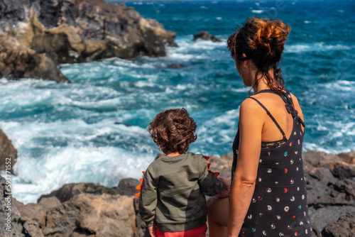 Mother and son on vacation at the Muelle de Orchilla on the southwest coast of El Hierro. Canary Islands © unai