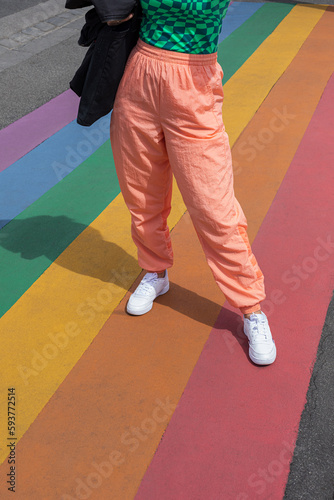 Woman standing on a rainbow colorful floor photo