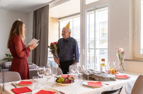 Birthday Celebration. Daughter Congratulating Her Senior Father. photo