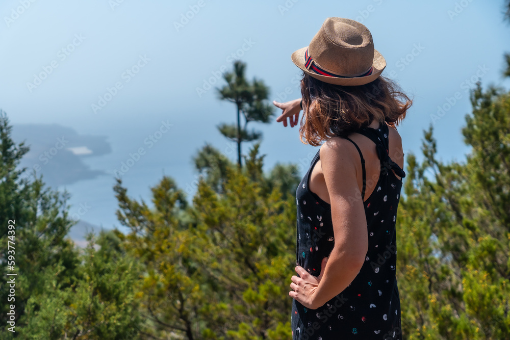 A female tourist with a hat at the El Julan viewpoint on the El Hierro, Canary Islands