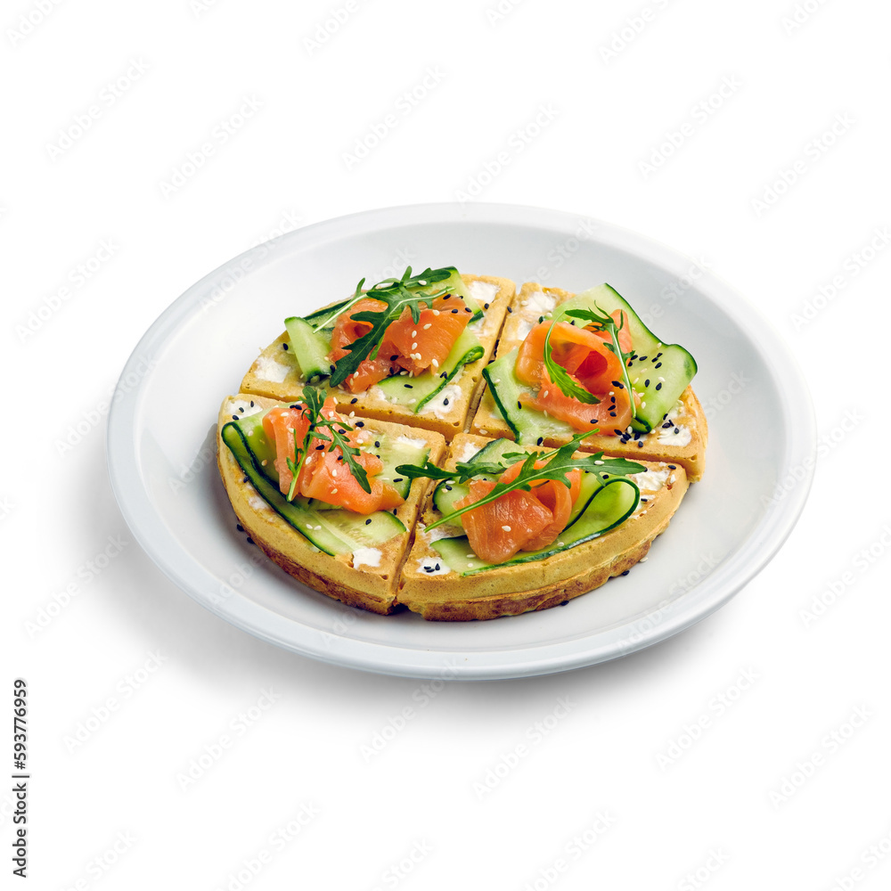 Salted Belgian waffles for breakfast on a white plate. Waffles with salmon, cream cheese, arugula and sesame seeds. On a white background. Isolated.