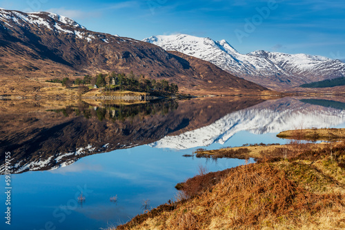 Snow covered mountains and hills reflected in Loch Cluanie at Glen Sheil, Scottish Highlands