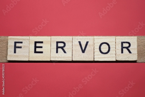 text the word fervor from gray wooden small letters with black font on an red table