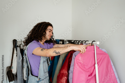 Man at home searcing for clothes to wear photo