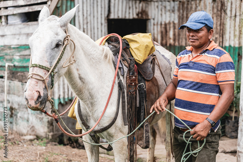 Portrait of a man beside his horse  photo