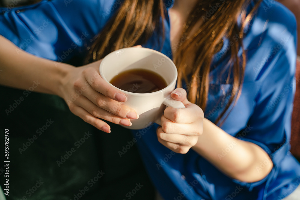 anonymous hands of woman drinking tea anonymous hands of woman drinking tea