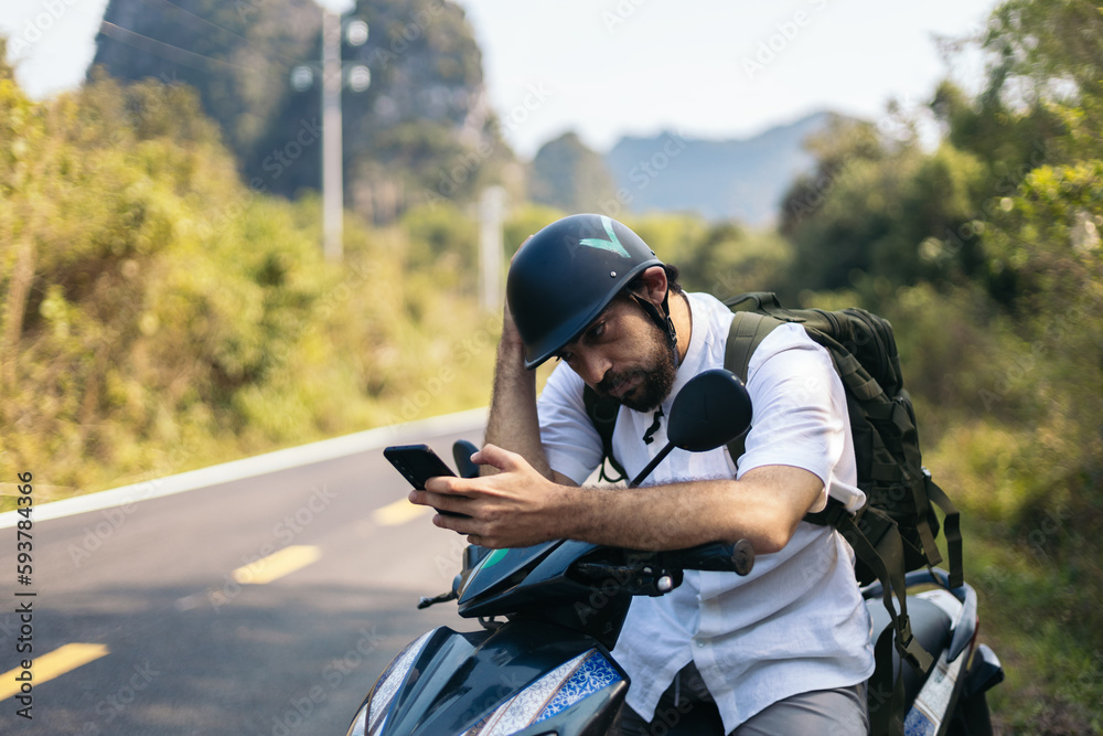 Tourist with a scooter in the countryside in Southeast Asia