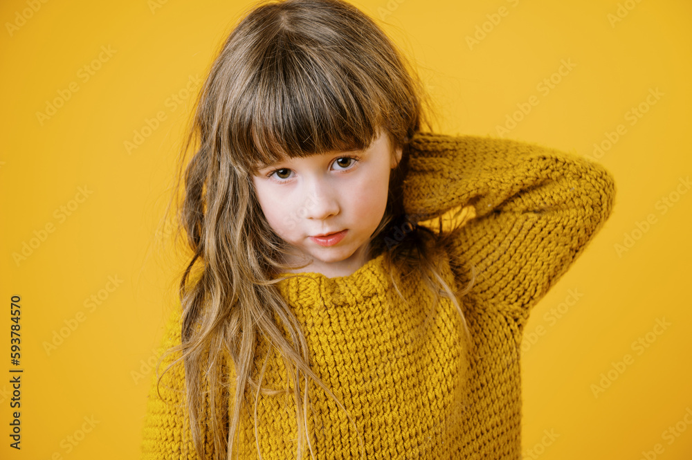 little girl in yellow knit sweater on yellow background little girl in yellow knit sweater on yellow background