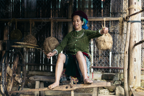 Vietnamese weaver working with hemp in the countryside photo