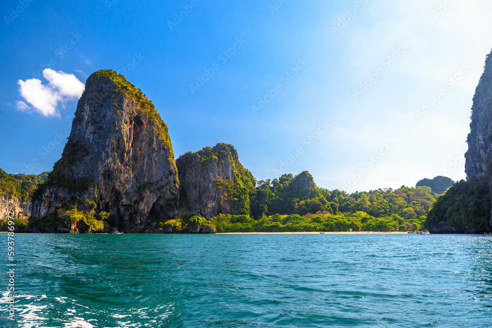 Fototapeta premium Huge cliff rocks in azure water, Railay beach, Ao Nang, Krabi, Thailand