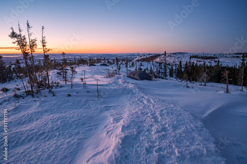 The famous Pioui trail on a cold winter morning as the sun rises, Grands-Jardins national park, Charlevoix, QC, Canada