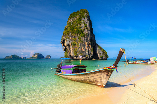 Long tail boats and cliff rock in azure water  Ko Rang Nok  Ao Phra Nang Beach  Ao Nang  Krabi  Thailand