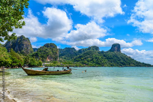 Long boats, rocks and cliffs covered with tropical trees, azure water on Ao Phra Nang Beach, Railay east Ao Nang, Krabi, Thailand