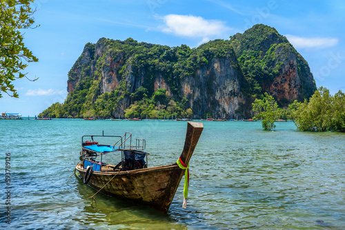 Boat in azure water with cliffs and rocks in the background, Ao Phra Nang Beach, Railay east Ao Nang, Krabi, Thailand