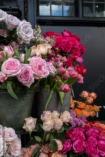 Bouquet of pink ranunculus and red rose. Decoration of the entrance of shop © elenarostunova