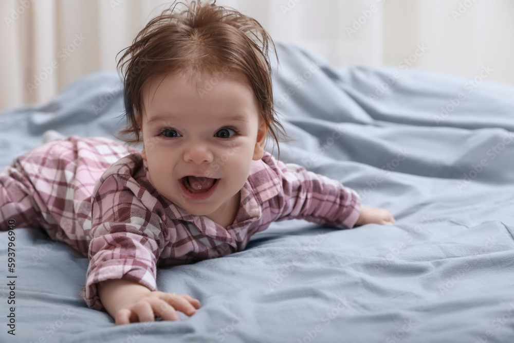 Cute little baby in pajamas on bed indoors. Space for text Cute little baby in pajamas on bed indoors. Space for text