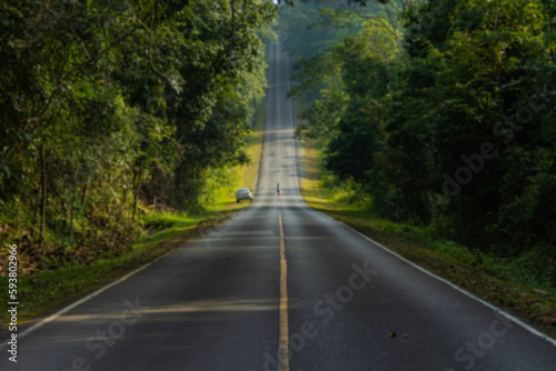 Blurred road in the middle of the forest and ascending to the top of the hill. in Khao Yai National Park, Thailand.