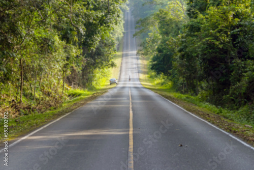 Blurred road in the middle of the forest and ascending to the top of the hill. in Khao Yai National Park  Thailand.