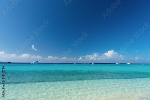 Fototapeta Naklejka Na Ścianę i Meble -  Grand Turk, Turks and Caicos - December 29, 2015: summer seascape with boat in turquoise water