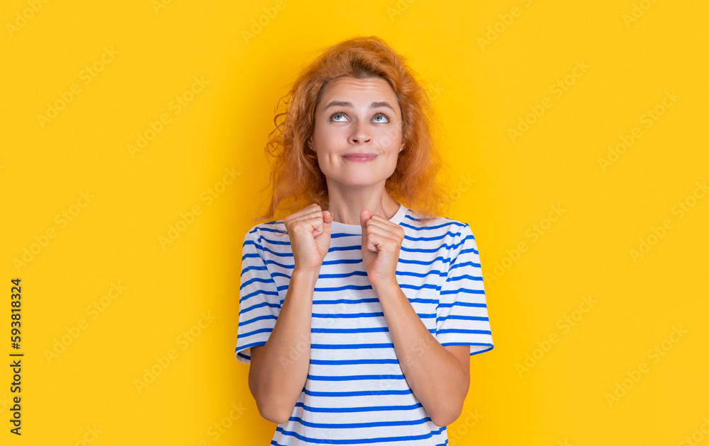 dreaming redhead woman portrait isolated on yellow background. portrait of young redhead woman dreaming redhead woman portrait isolated on yellow background. portrait of young redhead woman