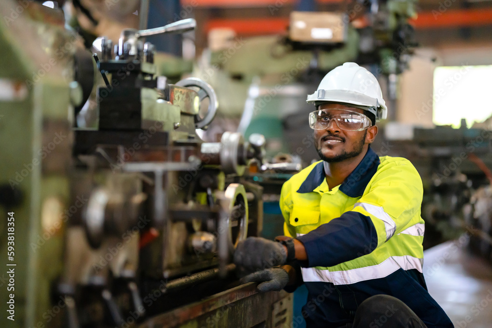 Production engineers in safety wear are assisting adjusting and maintaining CNC or factory machine, Male workers technician examining control the industrial tool, professional men at work in industry Production engineers in safety wear are assisting adjusting and maintaining CNC or factory machine, Male workers technician examining control the industrial tool, professional men at work in industry